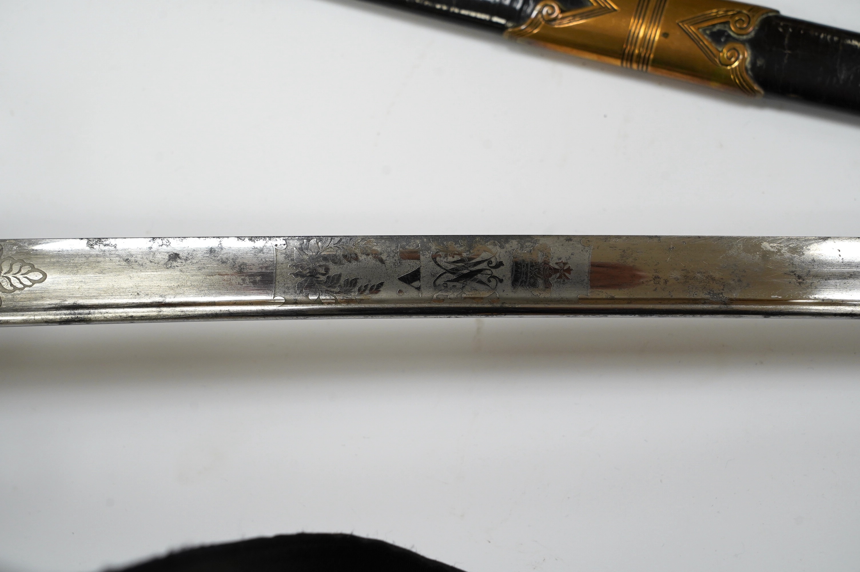 An early 19th century officer's sword, William IV cypher to knuckle guard, folding knuckle guard, engraved curved blade with William IV cypher and makers signature; ‘Vernon 4 Charing Cross London’, leather scabbard with